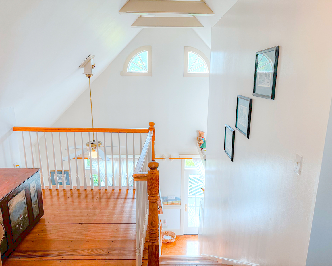 Image of the view down the staircase of the upstairs loft in the Carriage Bay Cottage.