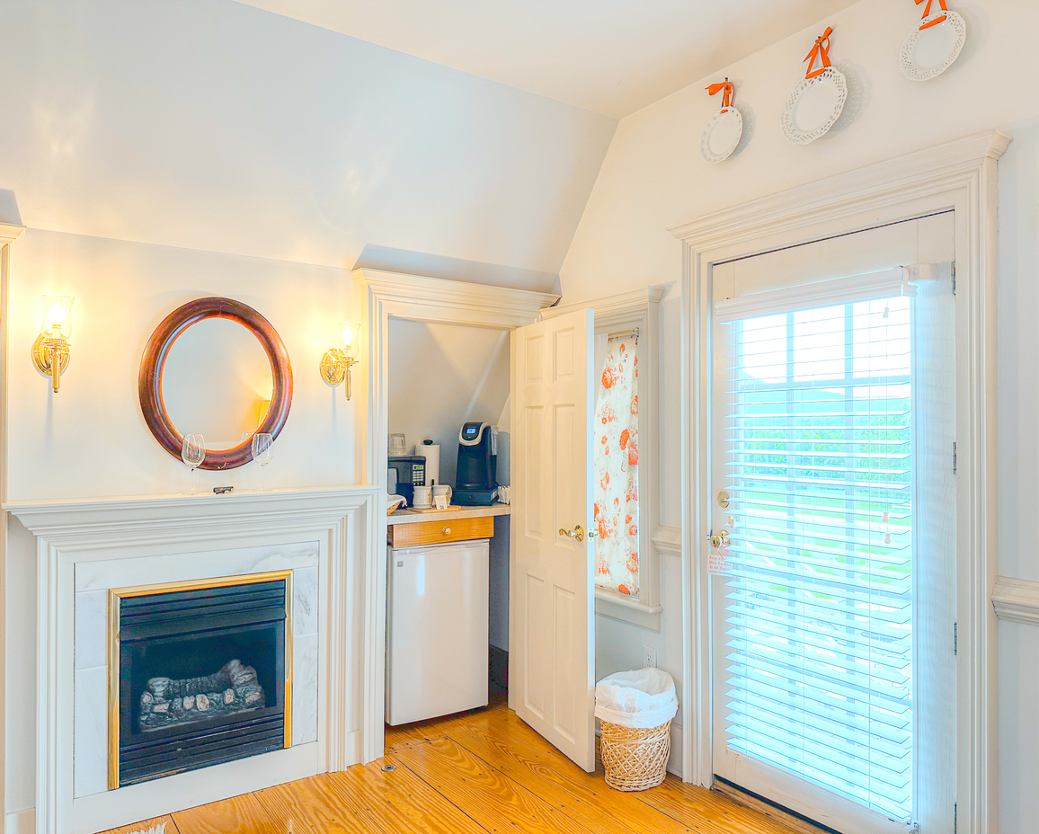 Image of the fireplace and kitchenette in the Dovecote Room.