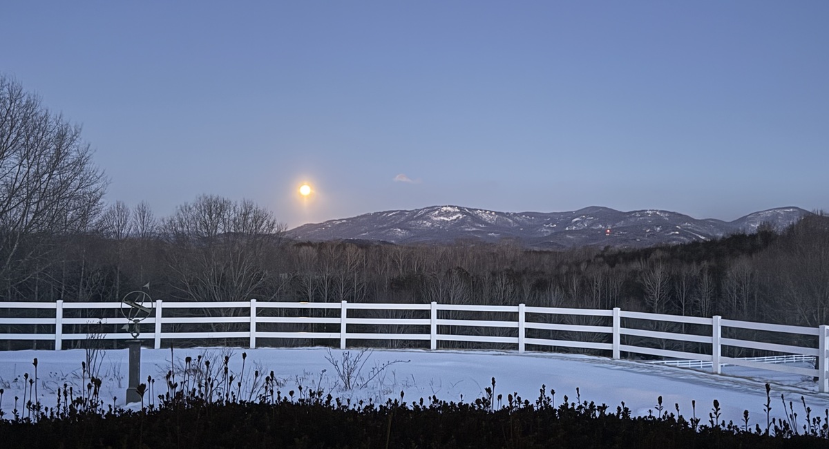 Moon setting over mountains