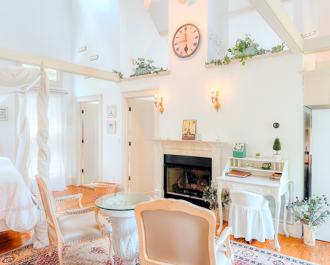 Image of the sitting area and fireplace in the bedroom of the Springhouse Cottage.